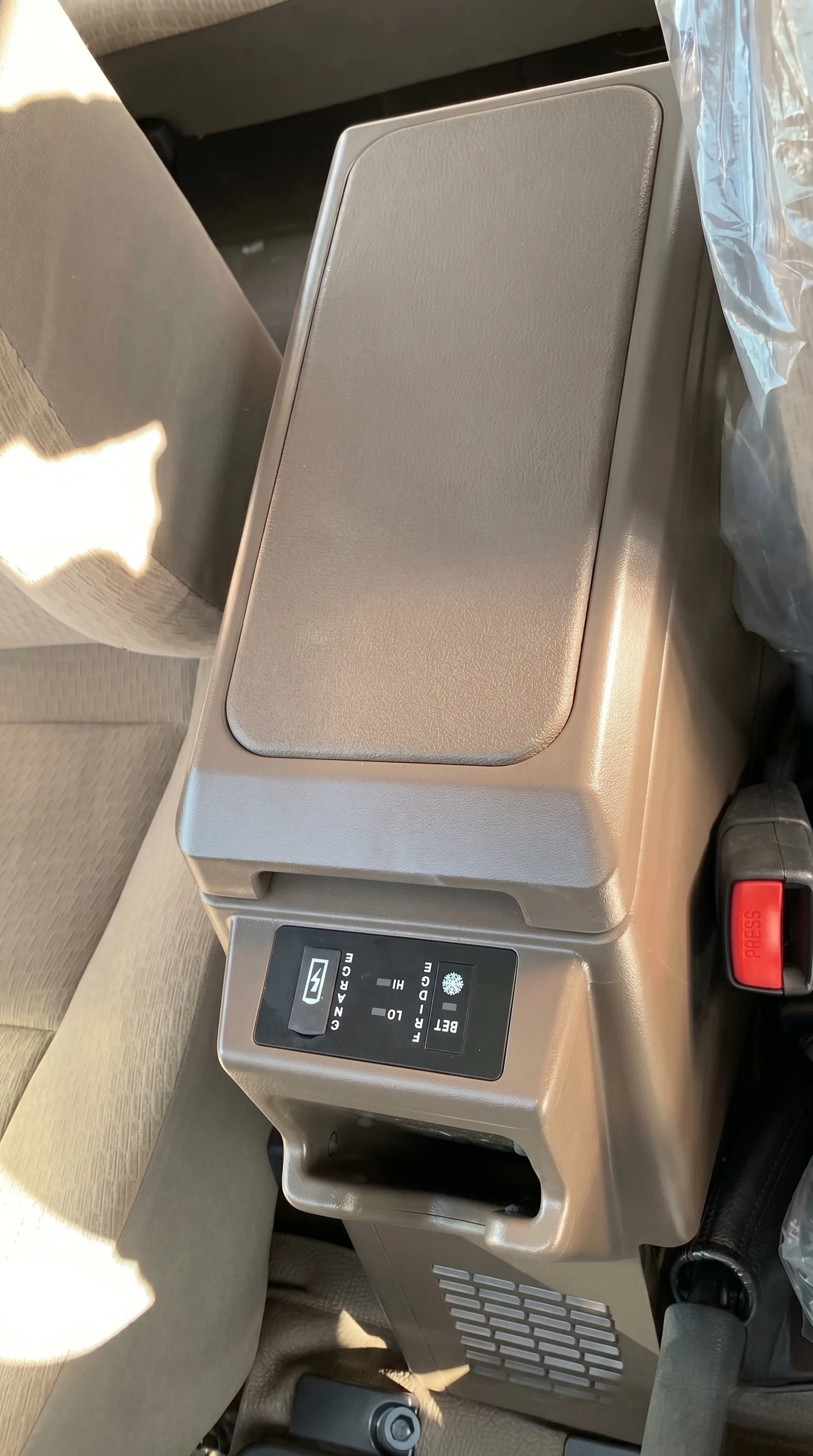 Toyota Land Cruiser 76 centre console fridge installed in brown interior view showing factory-fit look
