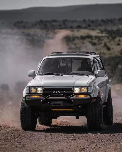 Toyota Land Cruiser 80 Series or Lexus LX450 fitted with Slee-Shortbus style heavy duty front bumper with fairlead mount for off-road protection running on gravel road