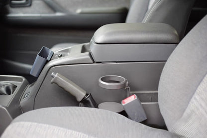 Toyota Land Cruiser 80 Series cup holder mounted to center console, middle arm rest side view shown without drink zoom in