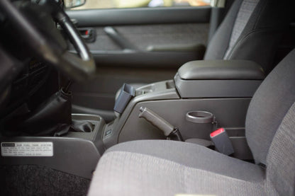 Toyota Land Cruiser 80 Series cup holder mounted to center console, shown without drink closed up