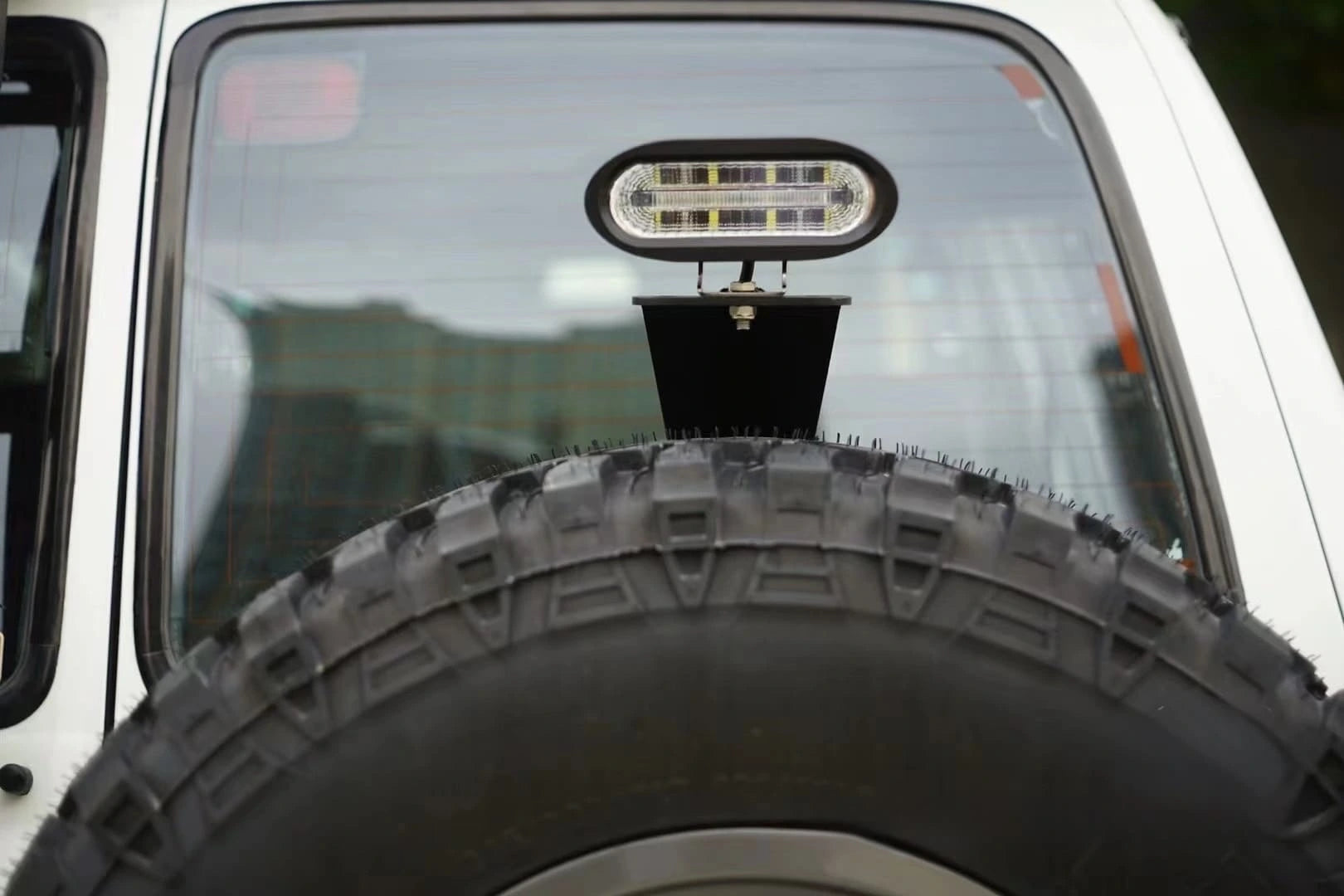 Toyota Land Cruiser 80 Series gx rear tire carrier 3rd brake light bracket metal spare wheel carrier mounted with led spot light closed up shot